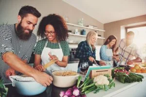 Group of people cooking together happily